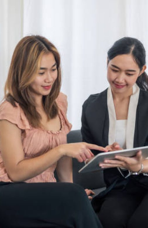 Asian woman insurance salesperson is presenting the policy details to the customer.